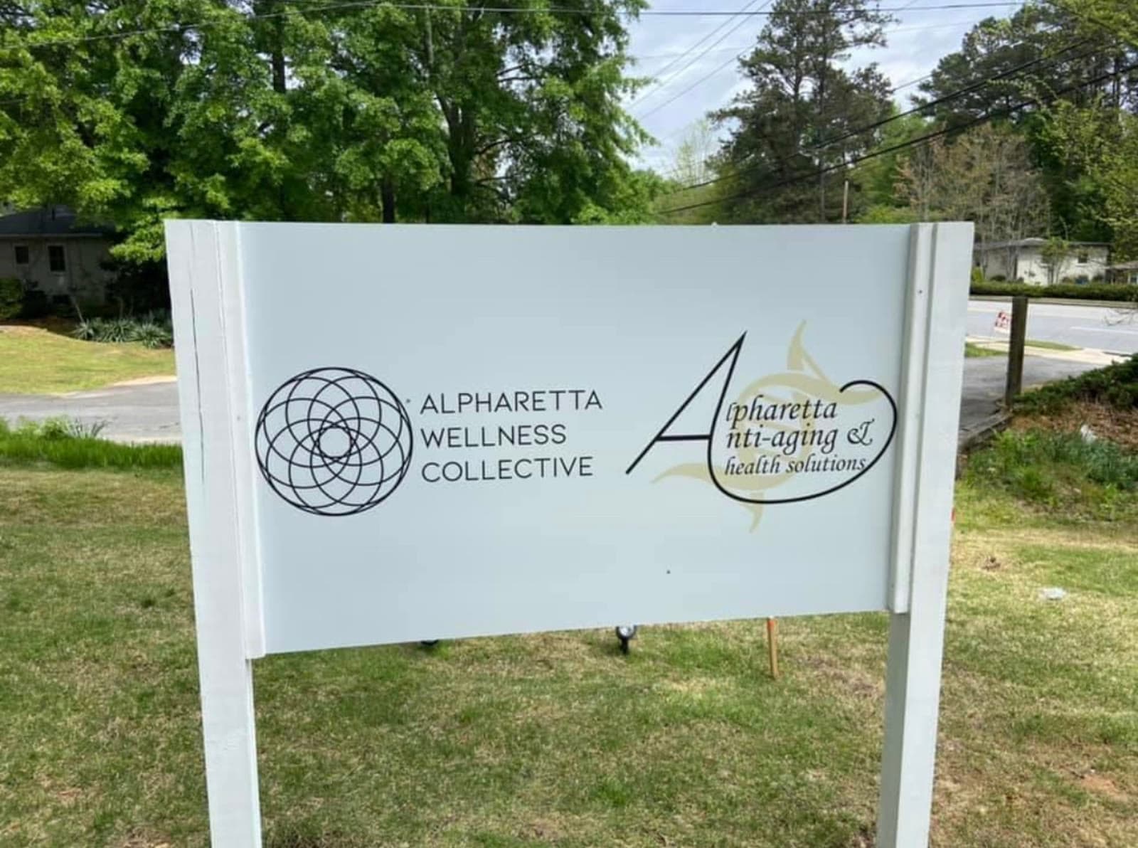 The Alpharetta Wellness Collective sign at the road on North Main Street.